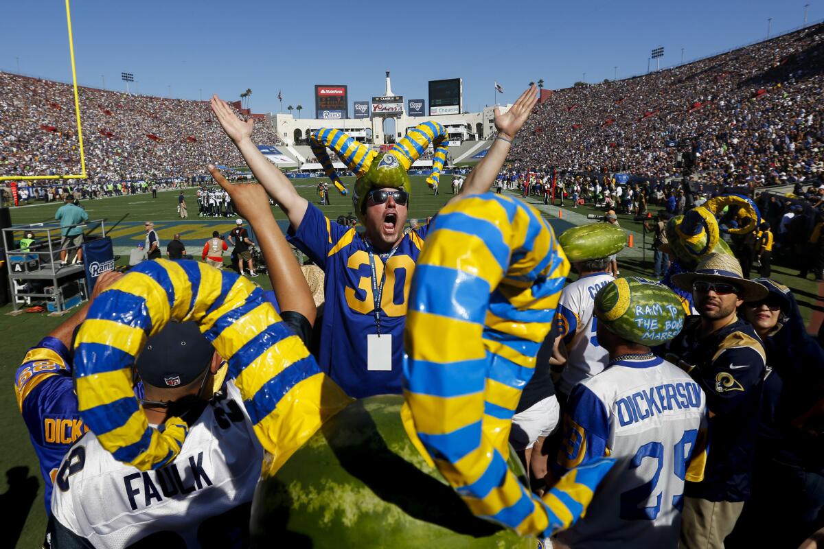 LA Rams Melonheads fans cheer during the Rams' home opener against the Seattle Seahawks at the Coliseum on Sept. 18.