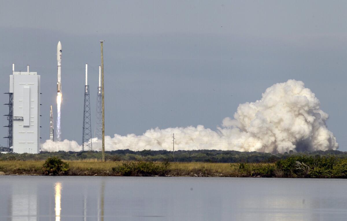 An Atlas V rocket, carrying an X-37B experimental robotic space plane, lifts off from Cape Canaveral Air Force Station in Florida.