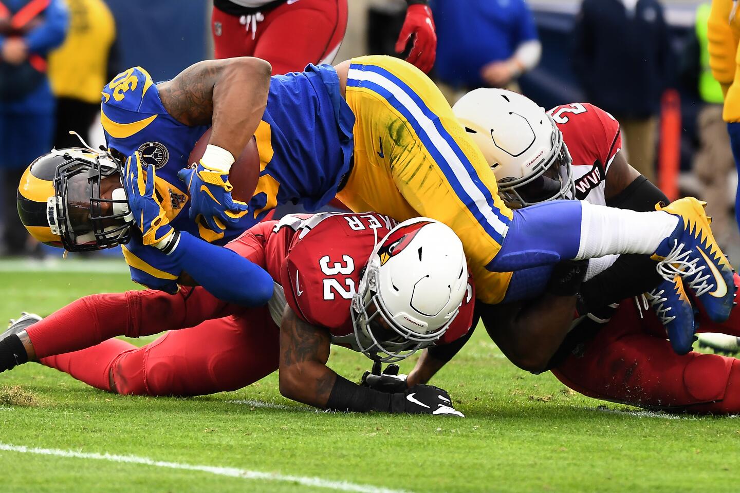 Rams running back Todd Gurley is stopped short of the goal line by Arizona Cardinals safety Budda Baker (32) and cornerback Patrick Peterson during the second quarter.