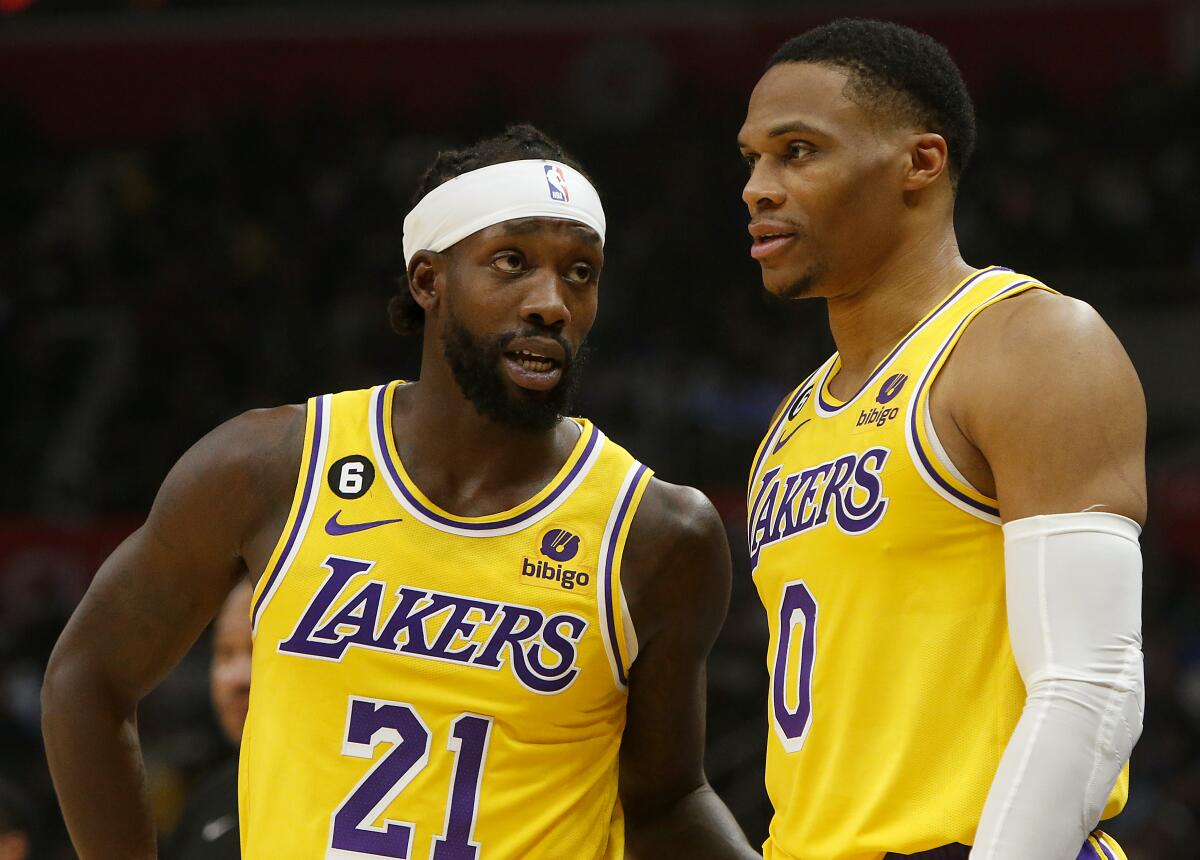 Laker guards Patrick Beverley, left, and Russell Westbrook talk during a break in the action