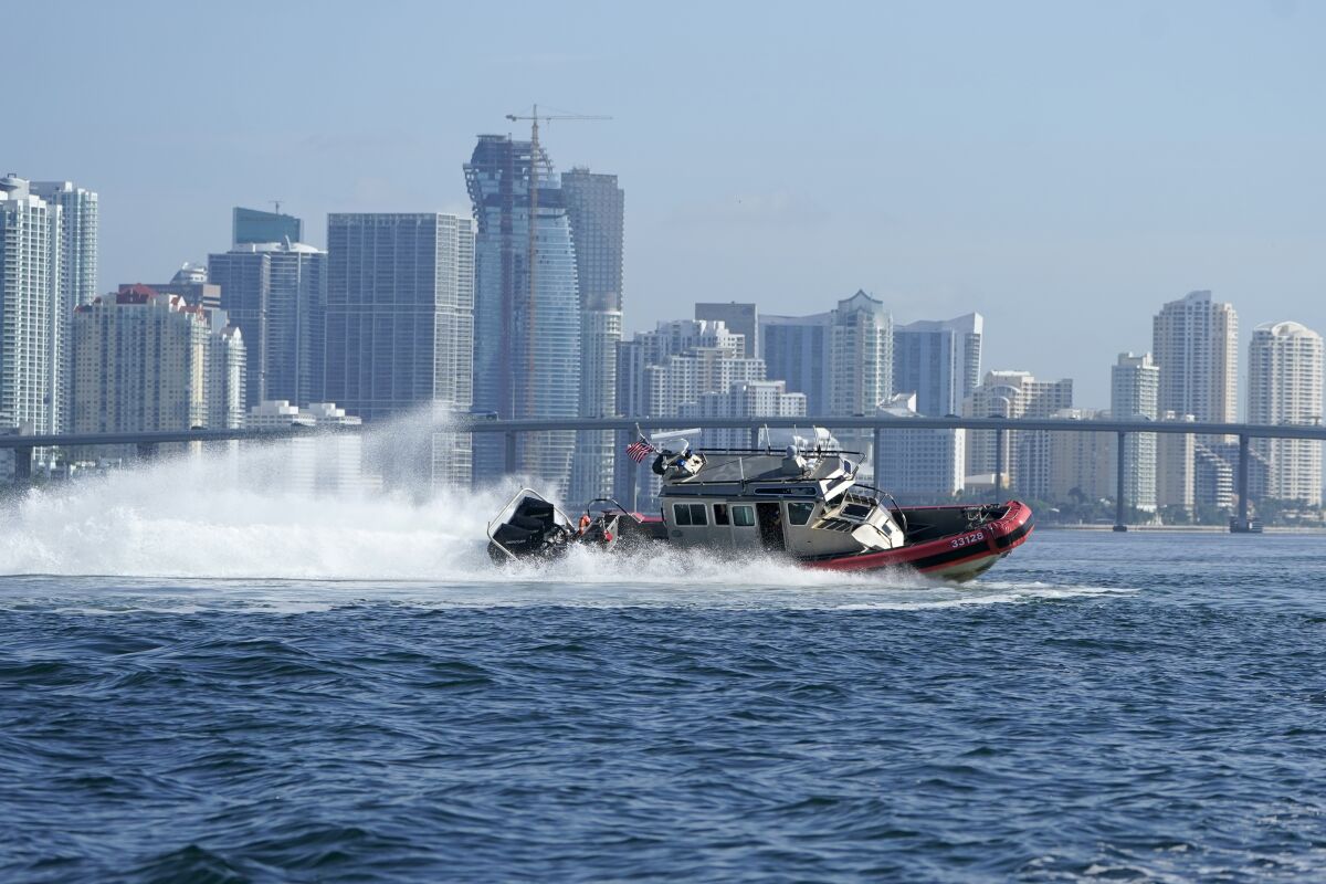 A U.S. Coast Guard boat with Miami coastal high rise building in the background