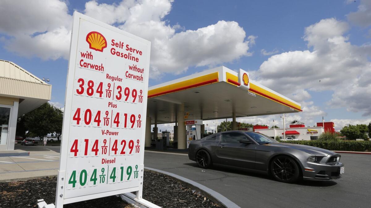 A car leaves a Shell station after getting gas in Sacramento on May 17.