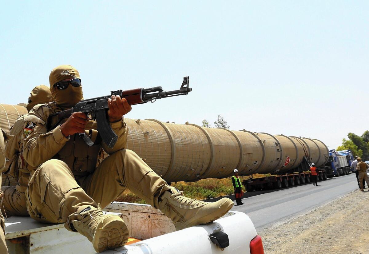 Soldiers guard a piece of equipment that was brought to an oil refinery east of Irbil, in Iraq’s semiautonomous Kurdish region.