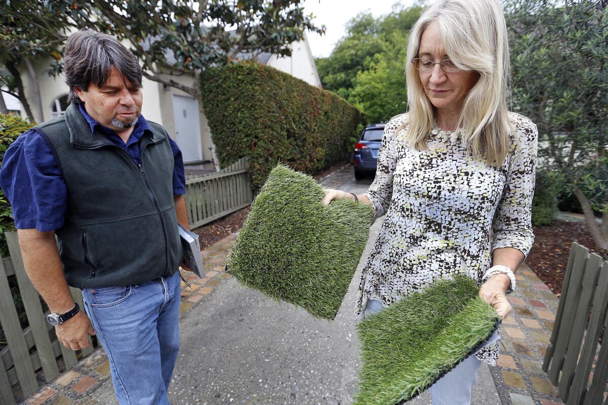 Tyler Mata, a water specialist in Santa Barbara which cut its water usage by 37% talks to homeowner Meg Miller about her choices in installing artificial sod.