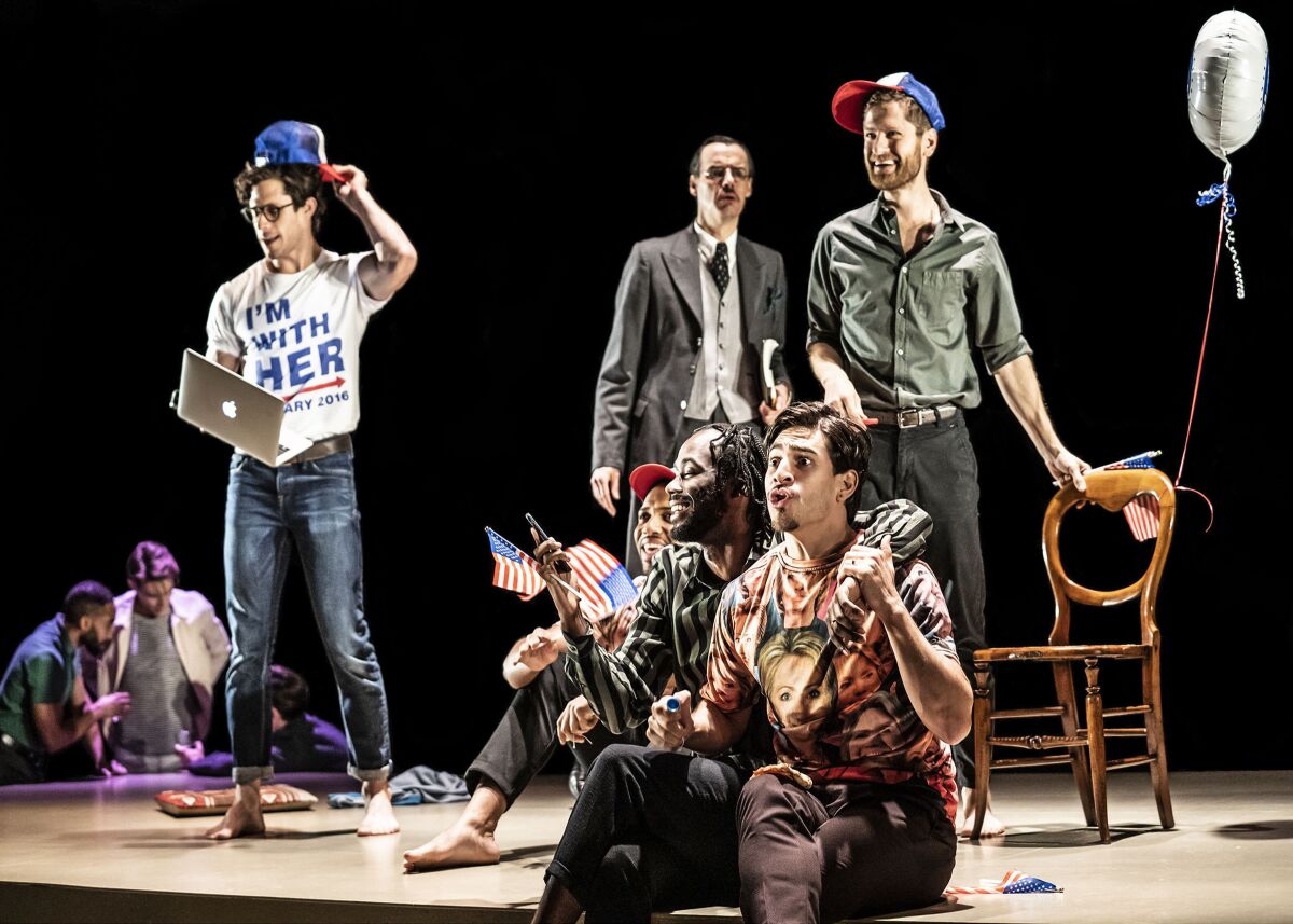 The cast of "The Inheritance" holds small flags and wears Hillary Clinton campaign paraphernalia.