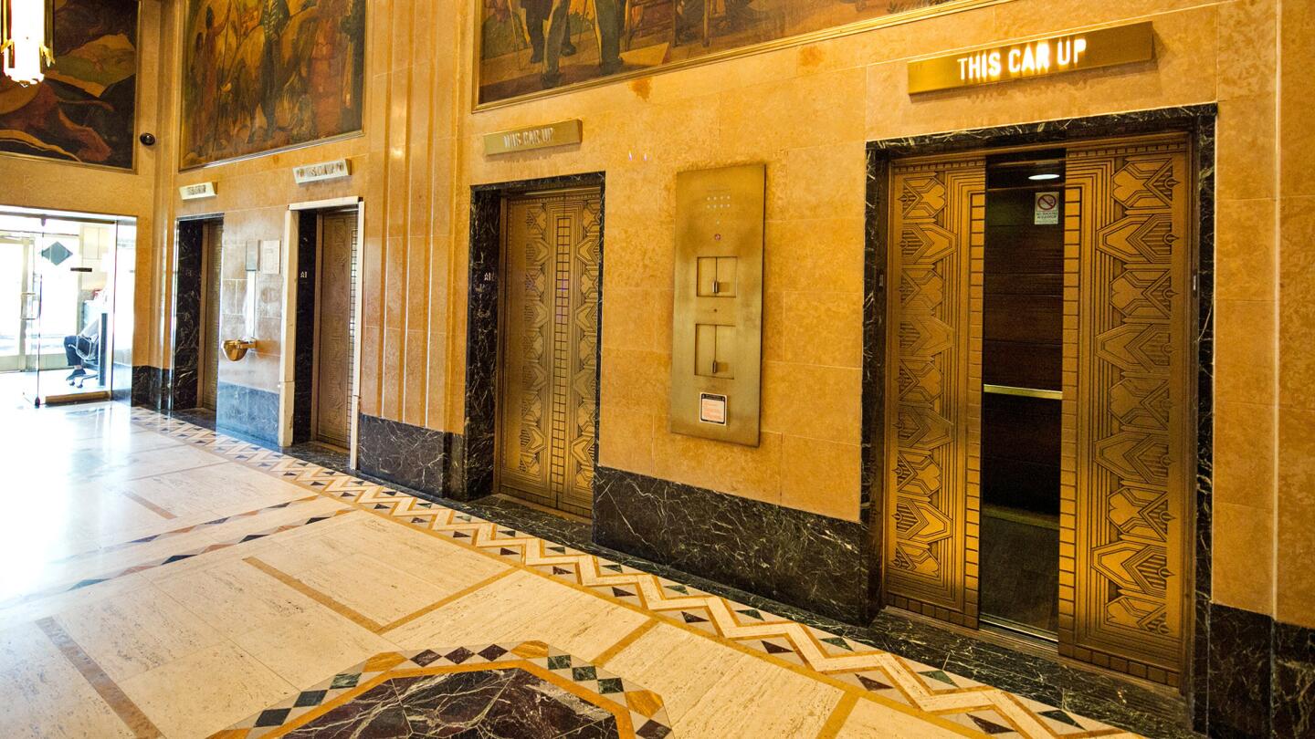 The lobby of the Title Guarantee Building, which features original elevators and architectural details.