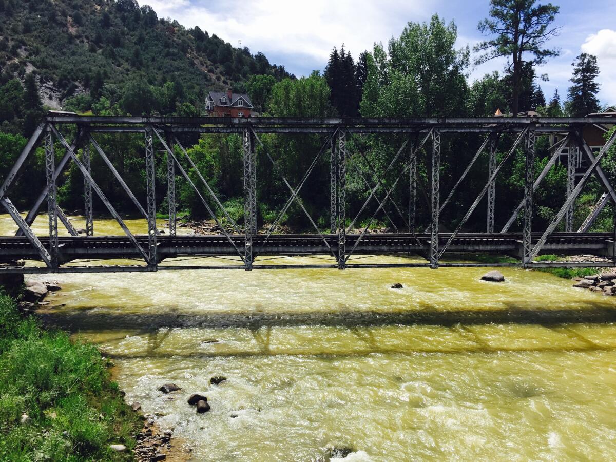 The Animas River flows through Durango, Colo., showing the effects of 3 million gallons of contaminated water that spilled from an old gold mine.