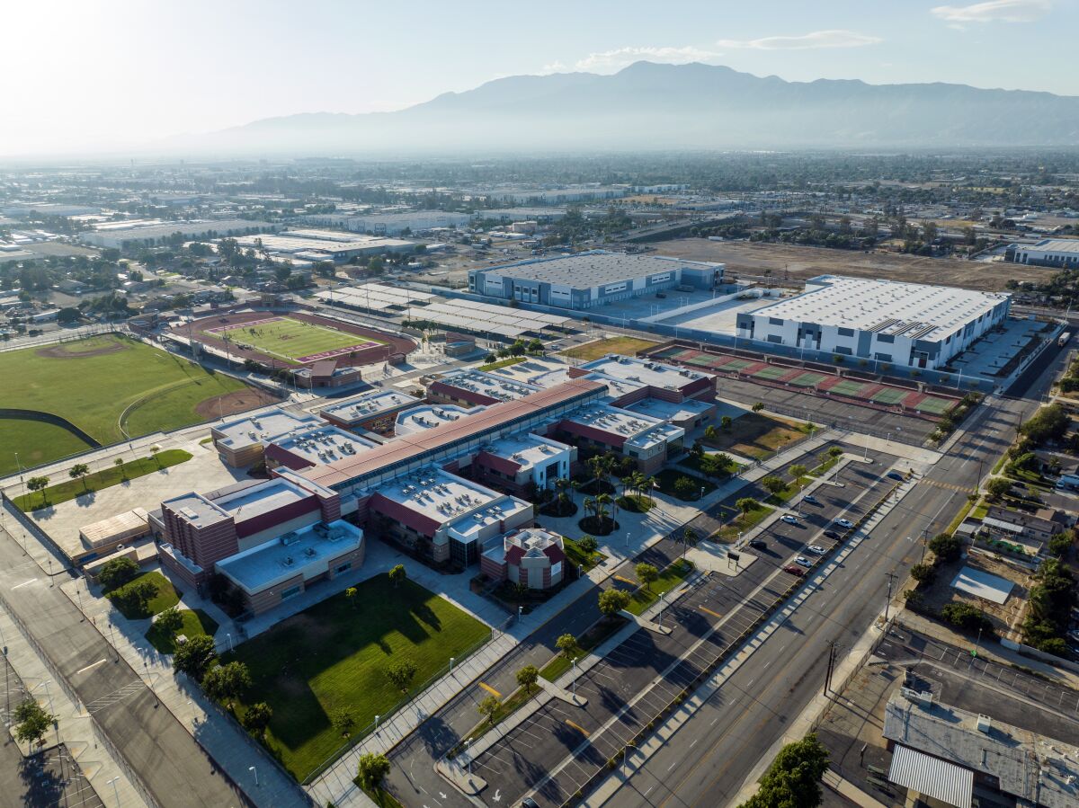 In a view looking northwest, Jurupa Hills High School sits among warehouses.