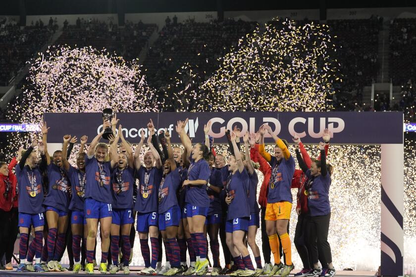 United States' Lindsey Horan holds the trophy alongside teammates after the United States defeated Brazil in the CONCACAF Gold Cup women's soccer tournament final match, Sunday, March 10, 2024, in San Diego. (AP Photo/Gregory Bull)