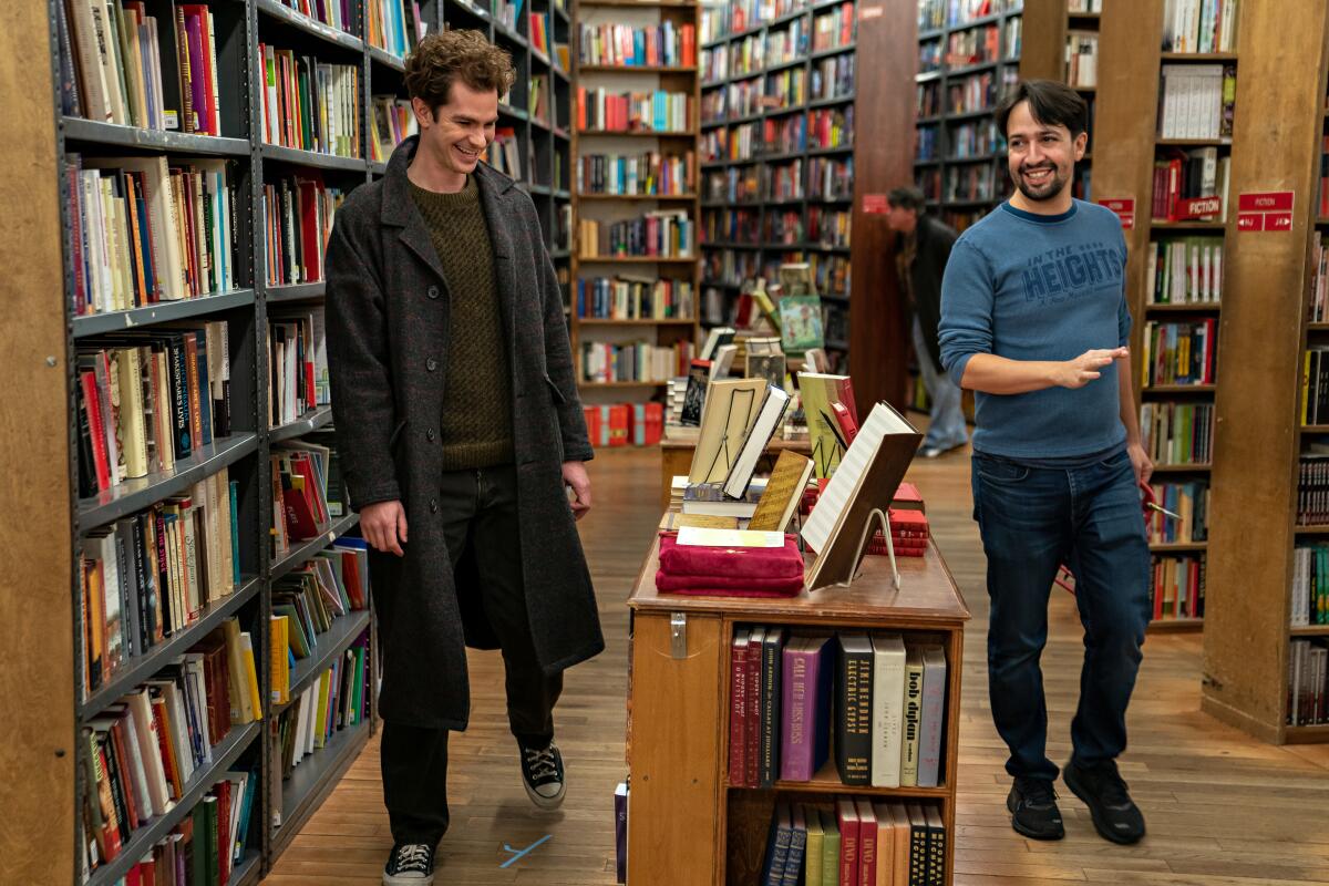 Andrew Garfield and Lin-Manuel Miranda in a bookstore