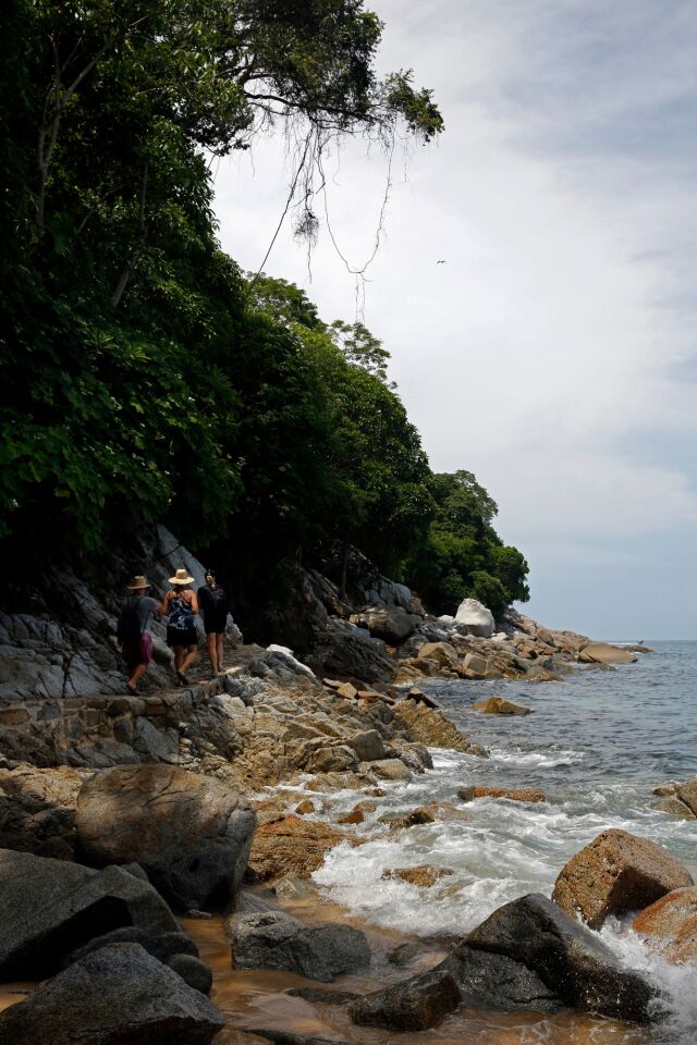 PUERTO VALLARTA, MEX-SEPTEMBER 1, 2019: A trail that hugs the shore takes people from Boca de Tomatlan to Quimixto on September 1, 2019 in Puerto Vallarta, Mexico. Here a group of travelers pass Playa Escondida towards Las Animas from Colomitos Cove. (Photo By Dania Maxwell / Los Angeles Times)
