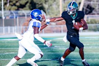 Running back Dijon Stanley of Granada Hills bullies his way past Palisades defender.