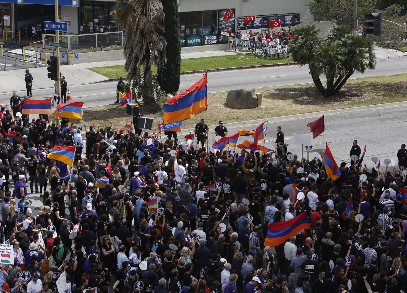 Armenian protesters, foreground, and a group of Turkish protesters, top, yell back and forth to each other during the rally outside of the Turkish Consulate on Wilshire Boulevard.