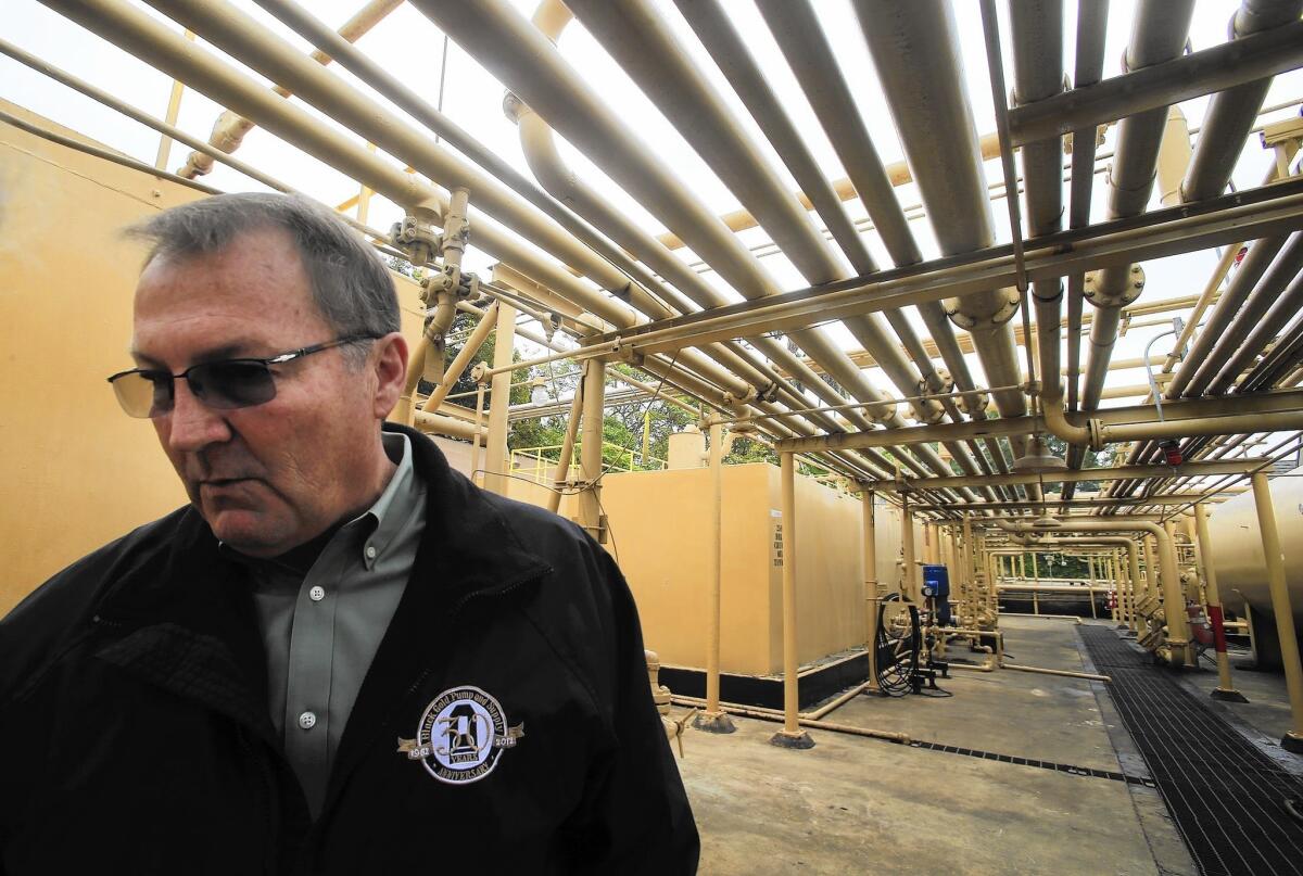AllenCo Energy Inc. executive Tim Parker gives a tour of the South L.A. facility in 2013.