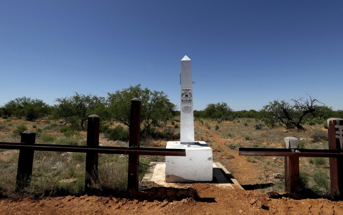 A border monument marks the boundary between the United States and Mexico in the Tohono O'odham Nation. (Luis Sinco / Los Angeles Times)