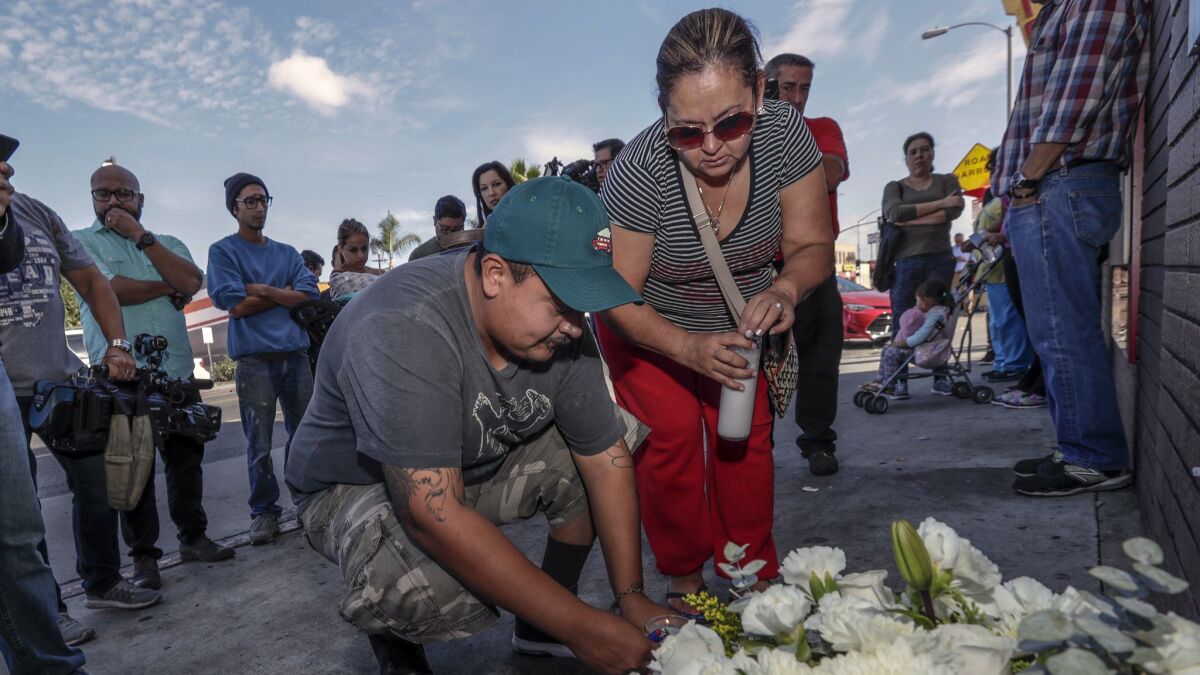 Luis Hernandez, left, and Araceli Cortez mourn the deaths of Jose Hernandez, 7, and Marcos Hernandez, 9, at a makeshift memorial on Indiana Street and Whittier Boulevard in Boyle Heights in November.
