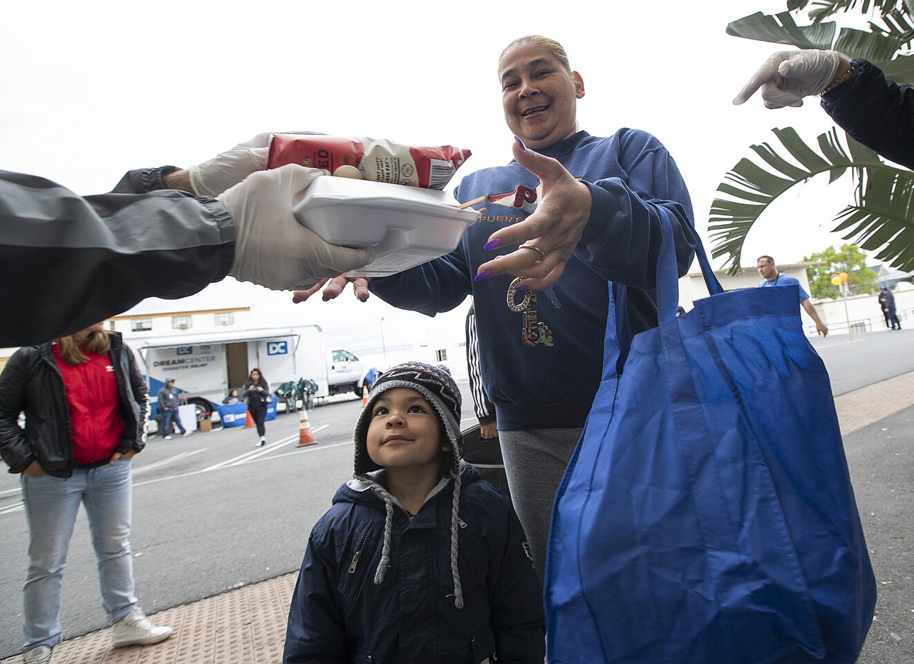 Cynthia Arenas picks up lunch for son Jezis, 4, at the Dream Center in L.A.