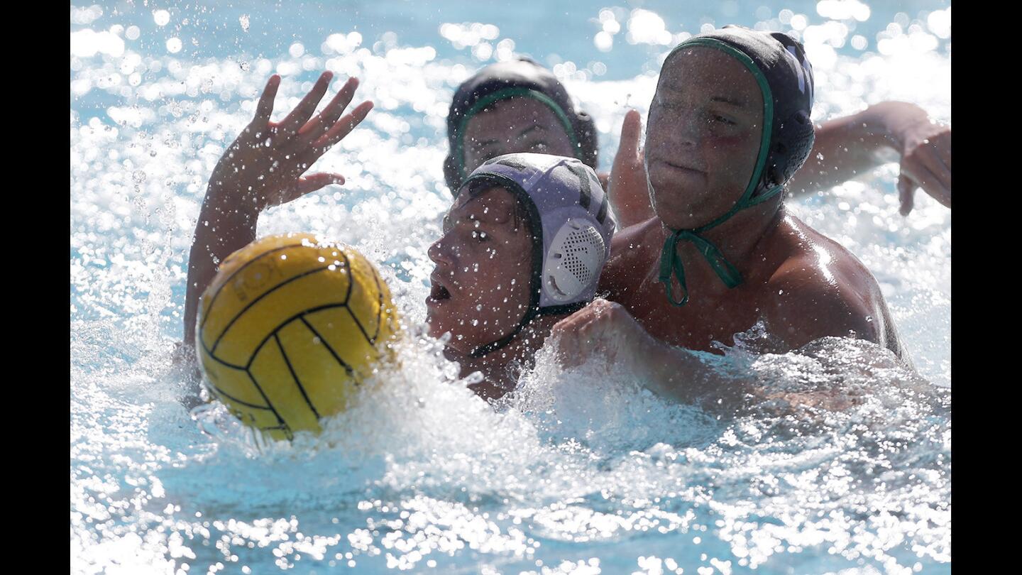 Costa Mesa High's Connor Westbrook, bottom left, battles Sage Hill's Matteo Merage, right, for the ball during the second half in a nonleague game in Newport Beach on Tuesday, Sept. 11.