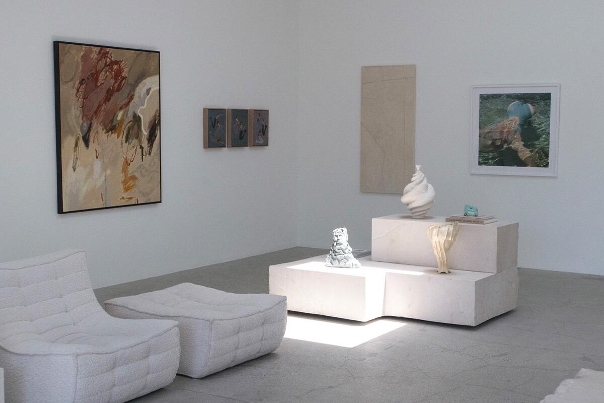 White furniture and art in a gallery