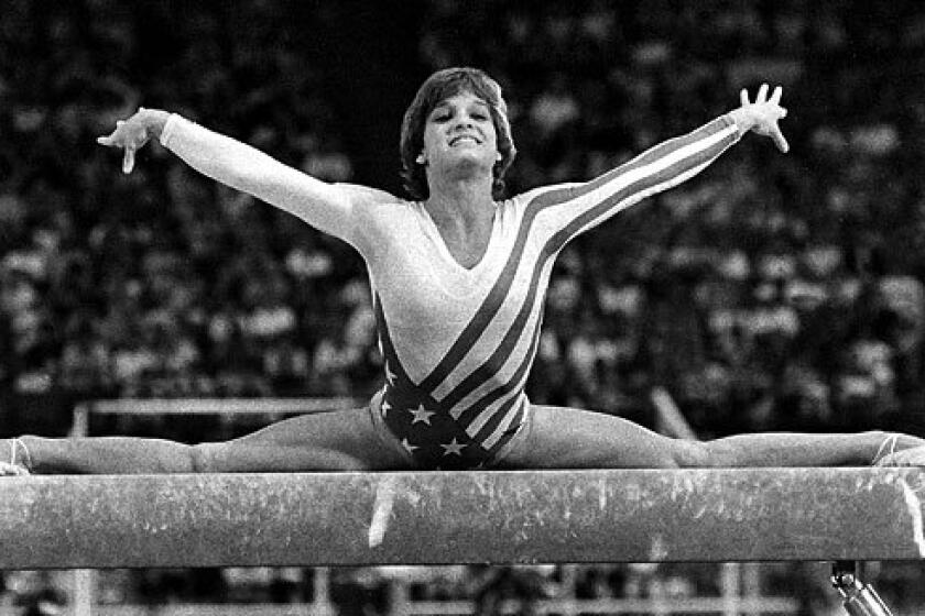 Mary Lou Retton performs on the balance beam.