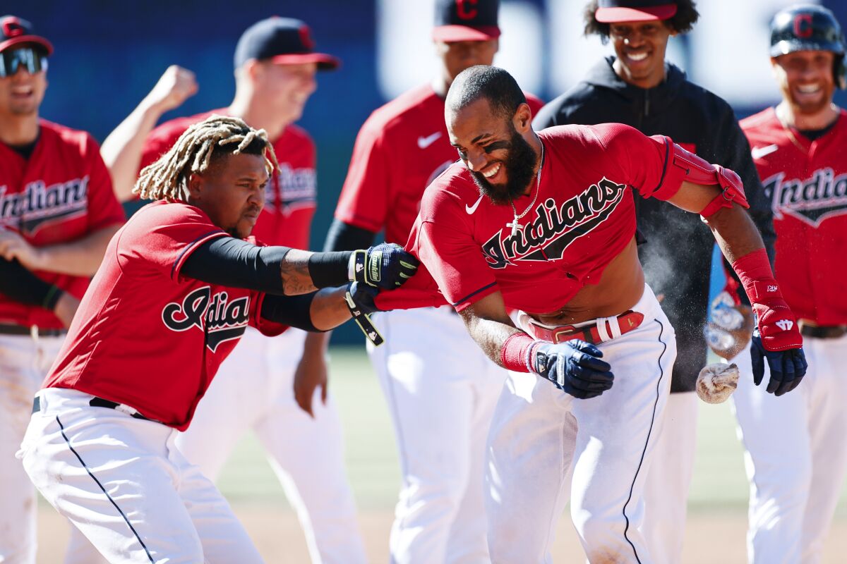 Cleveland Indians' Amed Rosario, right, celebrates with Jose Ramirez after hitting a game winning single off Chicago Cubs pitcher Keegan Thompson during the tenth inning of a baseball game, Wednesday, May 12, 2021, in Cleveland. The Indians defeated the Cubs 2-1. (AP Photo/Ron Schwane)