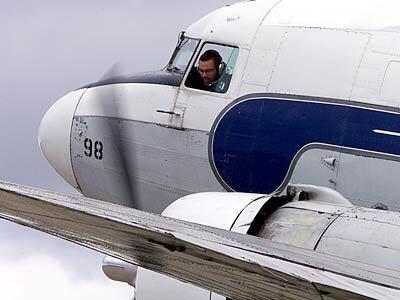 Pilot Jose Diaz fires up engines of a DC-3.