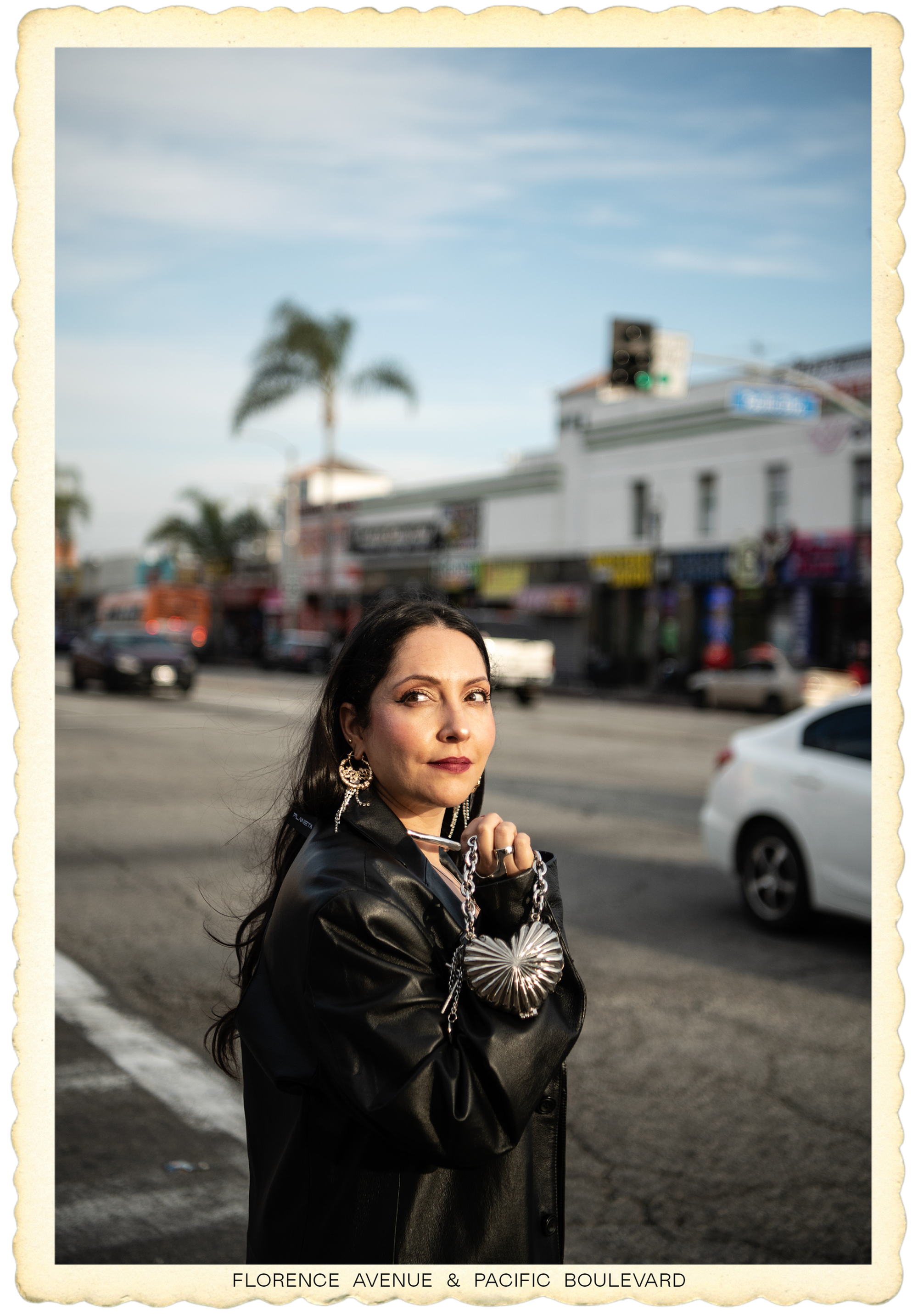 Anita Herrera on the corner of Florence and Pacific, holding a heart-shaped bag