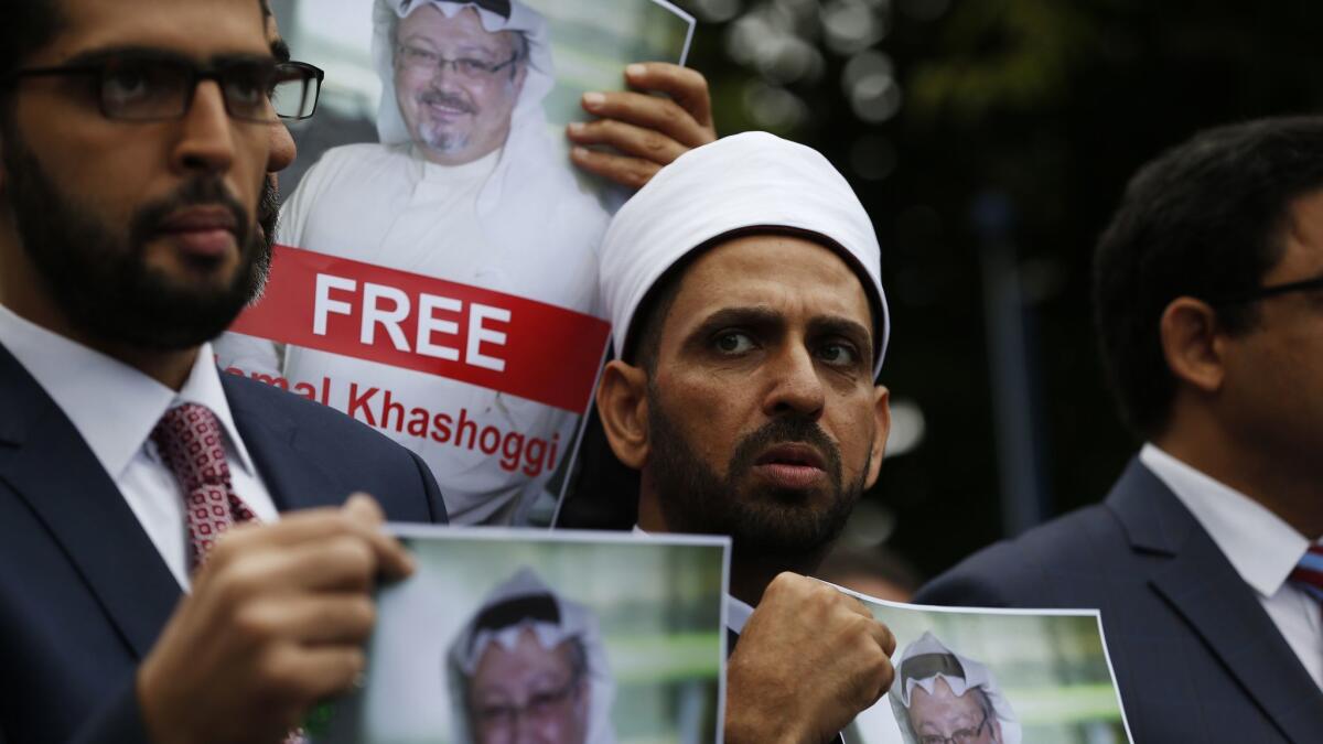 Members of the Turkish-Arab journalist association hold posters with photos of missing Saudi writer Jamal Khashoggi, as they hold a protest near the Saudi Arabia Consulate in Istanbul on Monday.