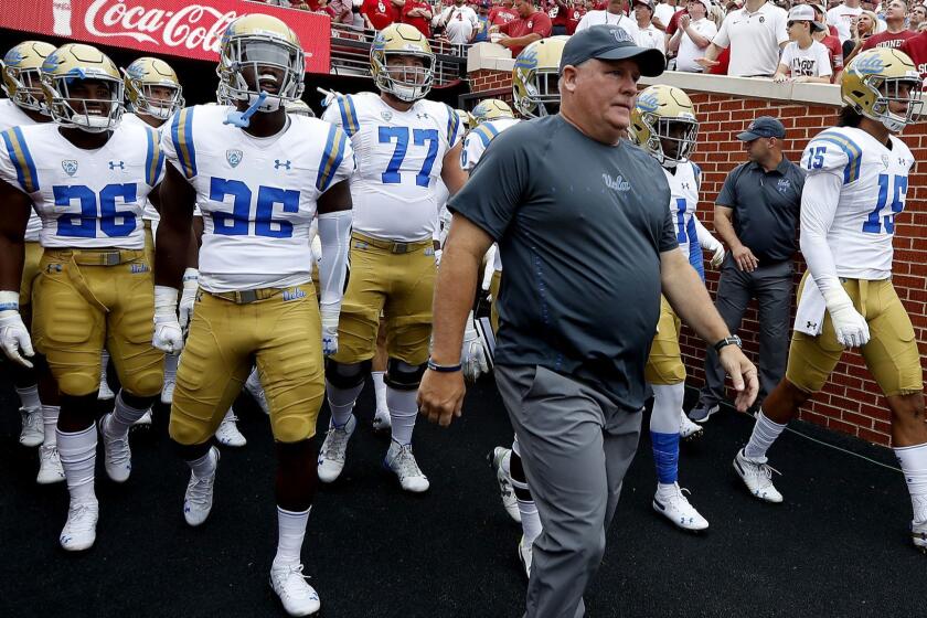 NIORMAN, OKLA.. - SEP. 8, 2018. UCLA head coach Chip Kelly leads his Bruin squad on the field at Memorial Stadium on the campus of the University of Oklahoma for a game against the Sooners on Saturday, Sept. 8, 2018,. (Luis Sinco/Los Angeles Times)