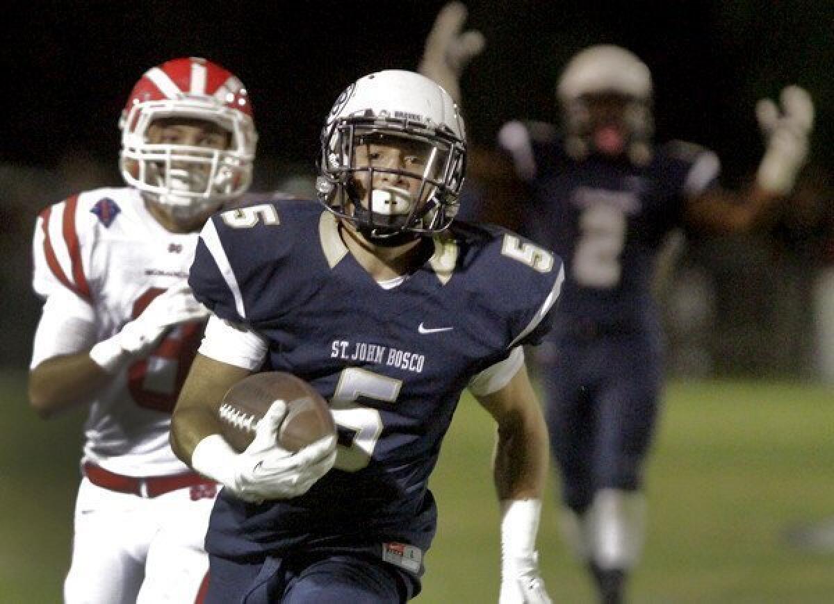 St. John Bosco running back Sean McGrew scores the first of his two touchdowns in the first half against Mater Dei on Friday night.