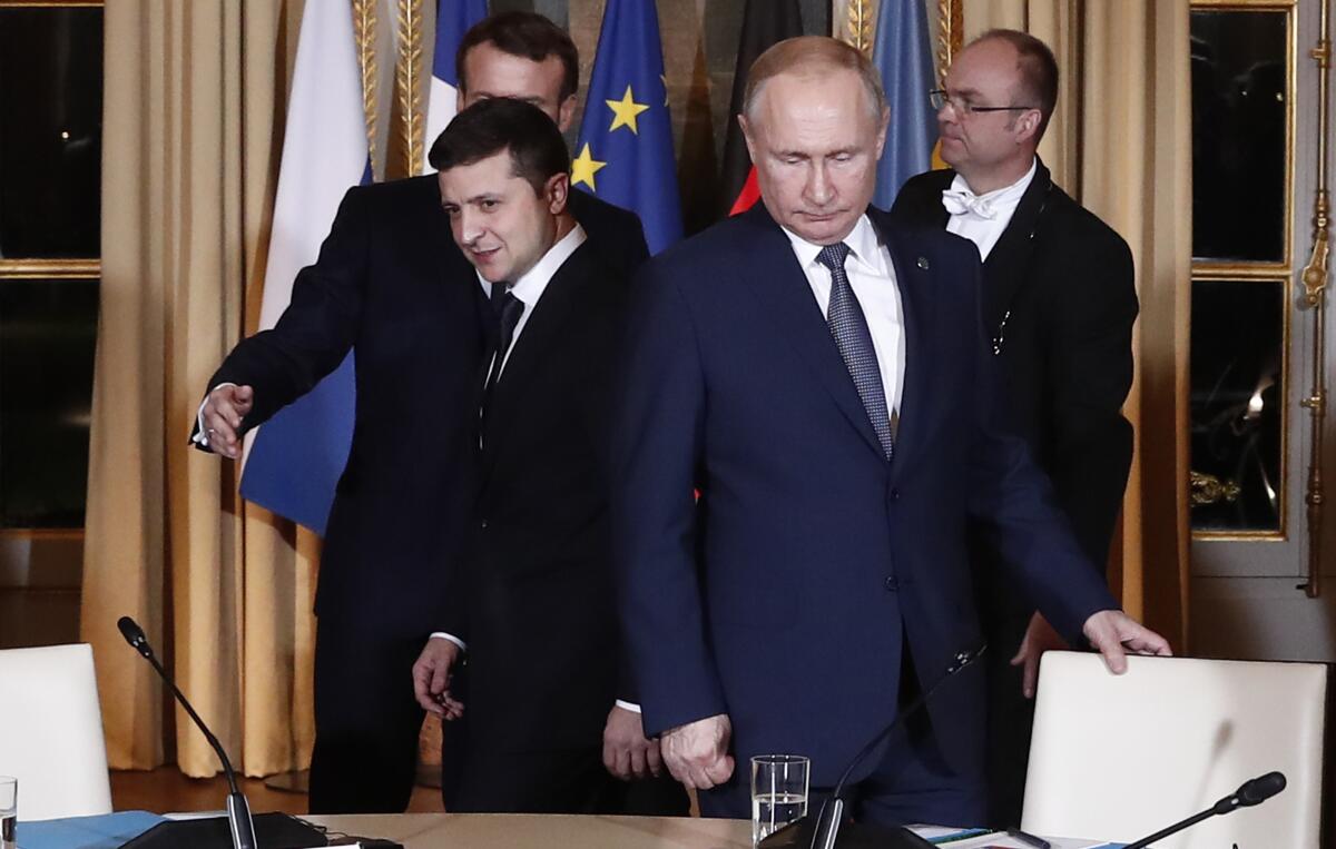 Vladimir Putin standing with three men, including Volodymyr Zelensky