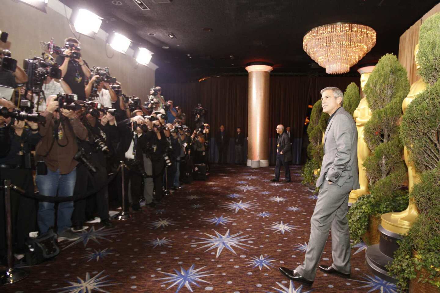 "The Descendants" nominee George Clooney braves the flashbulbs of numerous photographers.