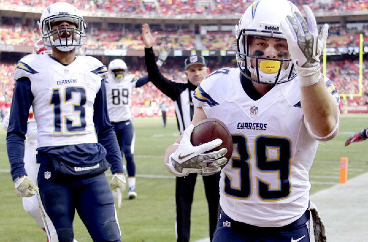 Chargers running back Danny Woodhead (39) heads to the stands to give a fan the ball after scoring a touchdown against the Kansas City Chiefs on Sunday at Arrowhead Stadium.