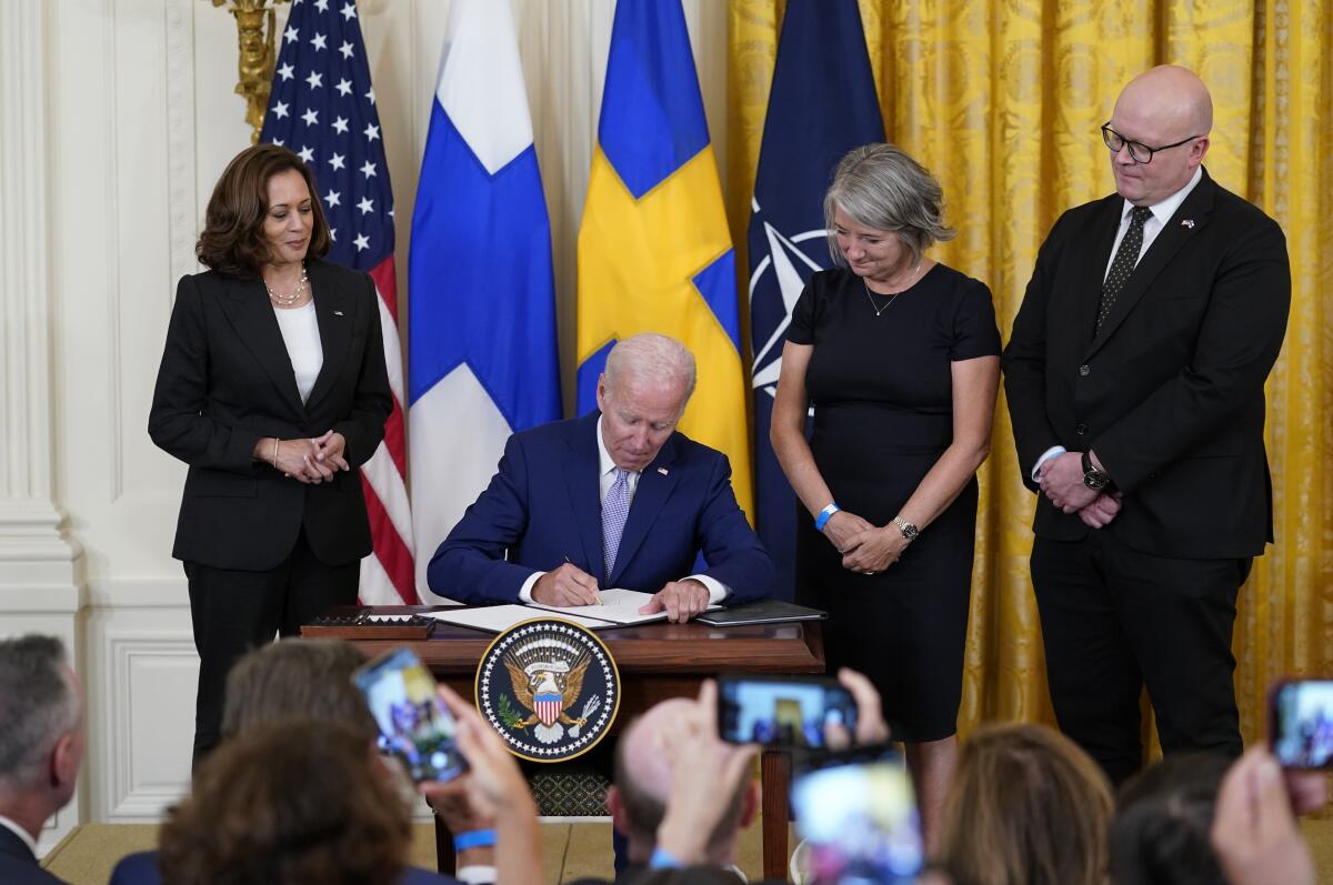 President Joe Biden signs the Instruments of Ratification for the Accession Protocols to the North Atlantic Treaty for the Kingdom of Sweden in the East Room of the White House in Washington, Tuesday, Aug. 9, 2022. From left, Vice President Kamala Harris, Biden, Karin Olofsdotter, Sweden's ambassador to the U.S., and Mikko Hautala, Finland's ambassador to the U.S. (AP Photo/Susan Walsh)