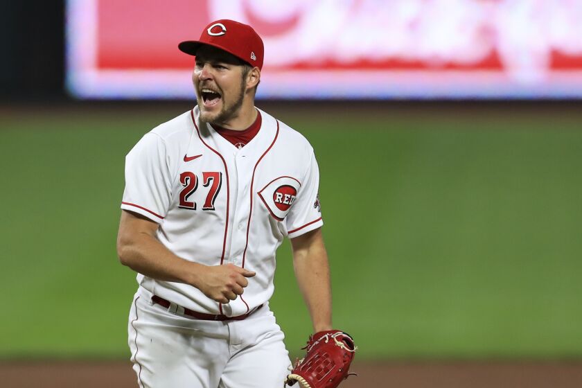 Cincinnati Reds' Trevor Bauer reacts after recording a strikeout against Milwaukee Brewers' Christian Yelich during a baseball game in Cincinnati, Wednesday, Sept. 23, 2020. The Reds won 6-1. (AP Photo/Aaron Doster)