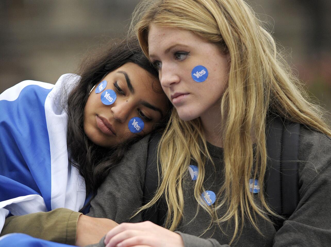 Pro-independence supporters console each other in Glasgow, Scotland, following a defeat in the referendum on Scottish independence.