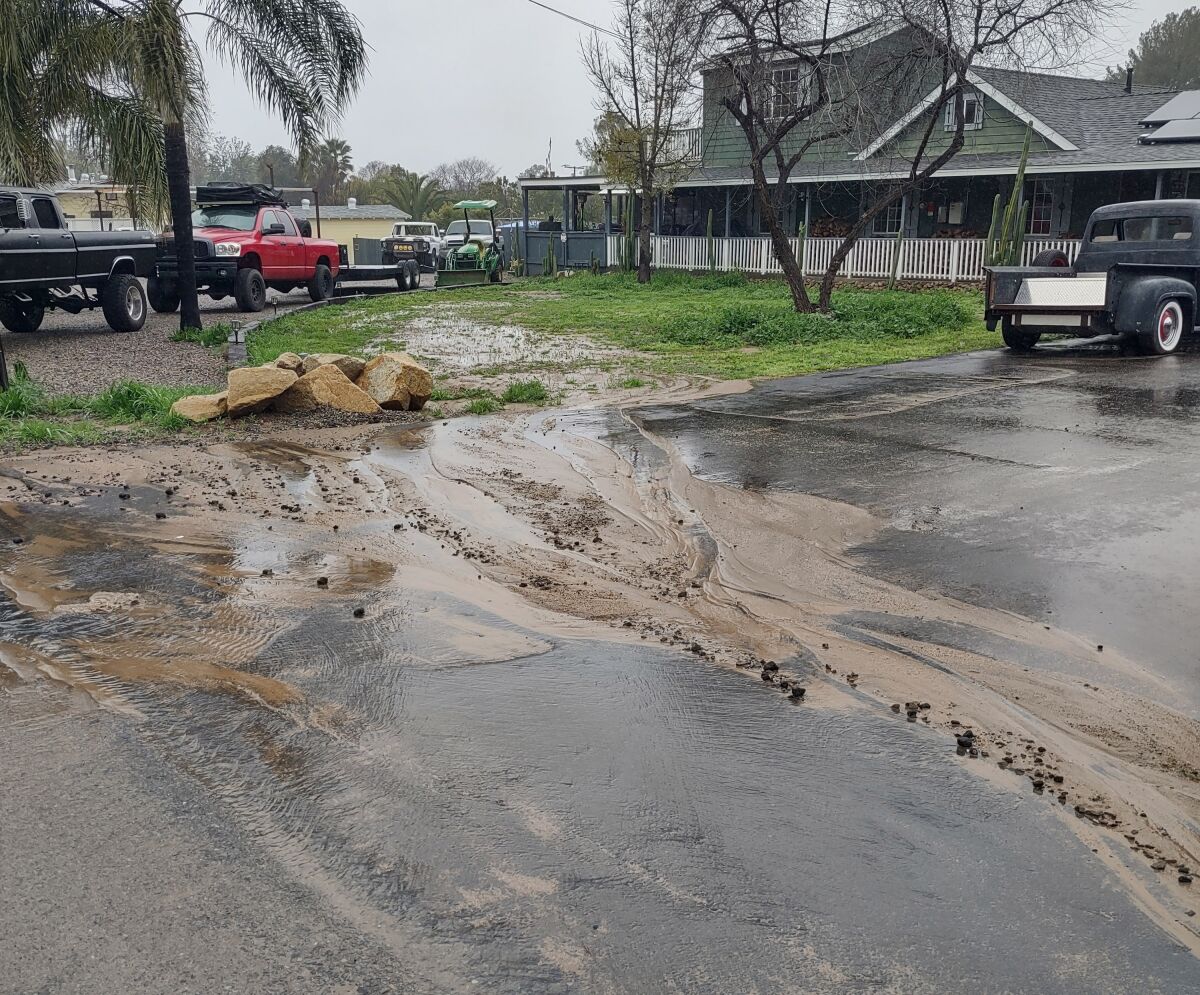 After recent heavy rains, water and mud flowed through F Street residential properties and accumulated in residents’ yards.