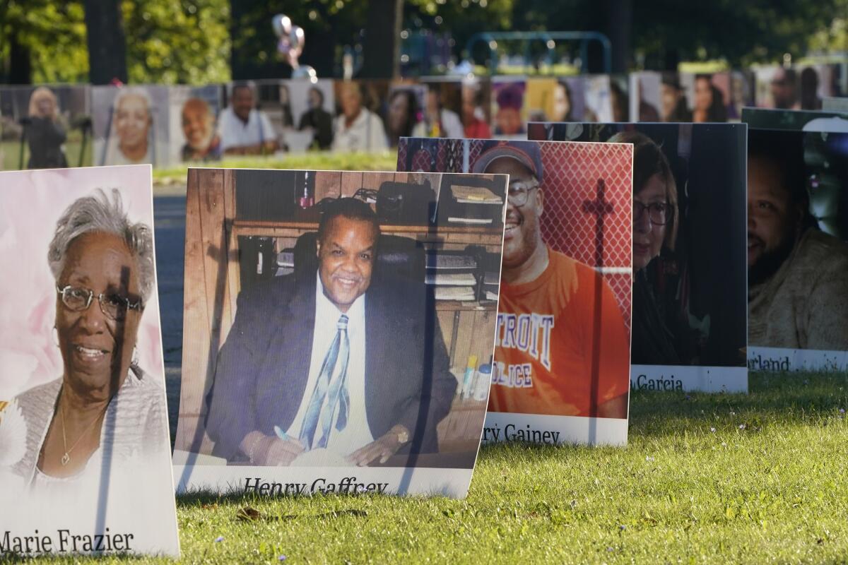 Some of the nearly 900 poster-sized photos of Detroit victims of COVID-19 are displayed Aug. 31 on Belle Isle in Detroit. 