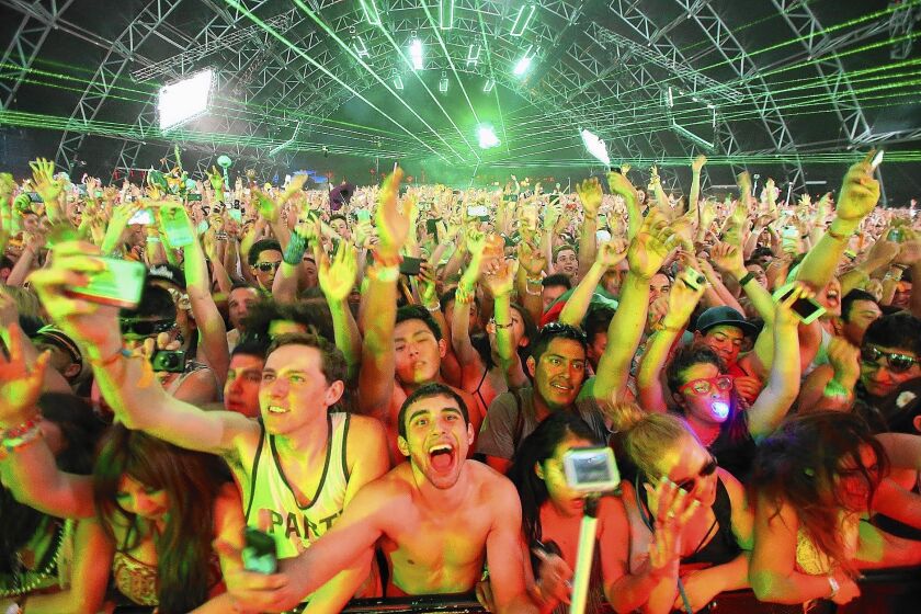 Fans of Martin Garrix dance during the Dutch electronic music producer's concert at the Coachella Valley Music and Arts Festival on Friday.