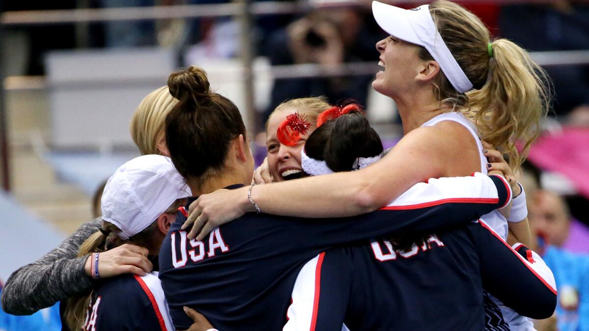 CoCo Vandeweghe, right, celebrates with U.S. teammates after she won a doubles match with Shelby Rogers, center, to defeat Belarus for the Fed Cup title on Sunday.