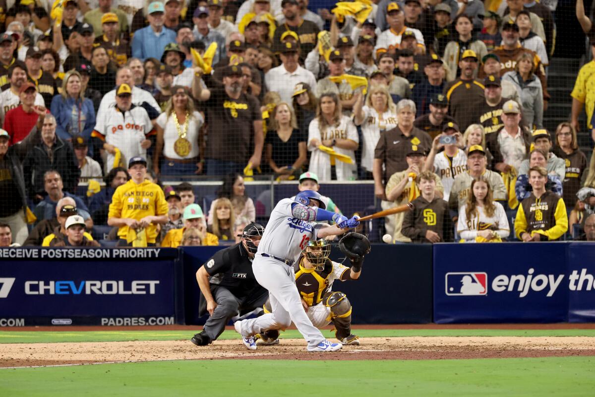 Dodgers batter Max Muncy strikes out in the eighth inning against the Padres on Friday.