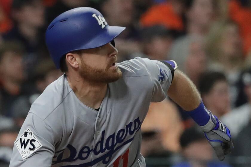 Los Angeles Dodgers' Logan Forsythe hits a double during the fourth inning of Game 5 of baseball's World Series against the Houston Astros Sunday, Oct. 29, 2017, in Houston. (AP Photo/David J. Phillip)