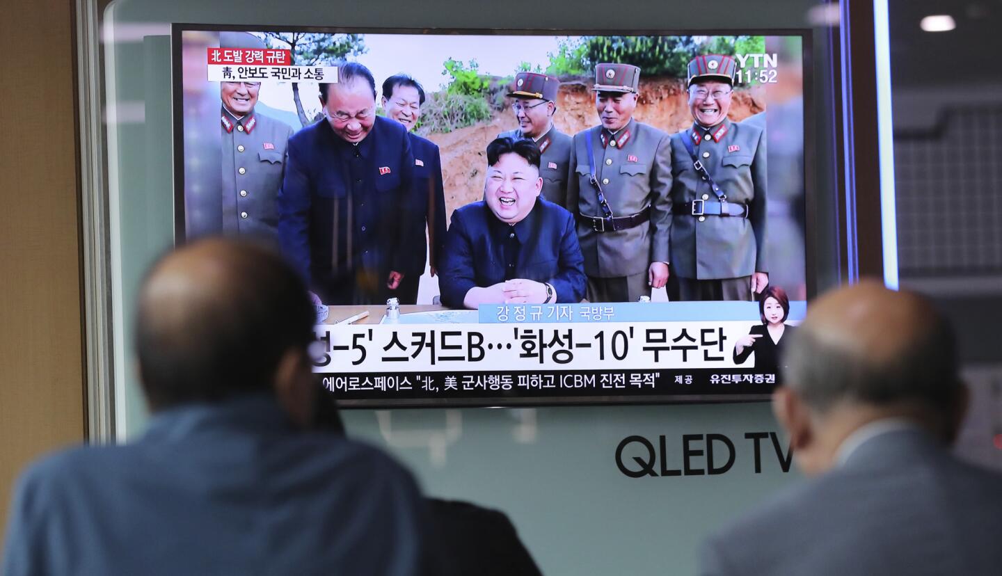 People watch a TV news program showing an image of North Korean leader Kim Jong Un, published in the country's Rodong Sinmun newspaper, at Seoul Railway station in Seoul, South Korea, Monday, May 15, 2017. North Korea said Monday the missile it launched over the weekend was a new type of "medium long-range" ballistic rocket that can carry a heavy nuclear warhead. A jubilant leader Kim Jong Un promised more nuclear and missile tests and warned that North Korean weapons could strike the U.S. mainland and Pacific holdings.