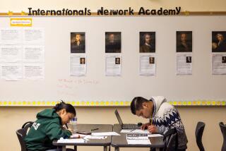 Los Angeles, CA - January 22: 10th grade world history students Leonara F., left and Walter C. work on their school work at The Internationals Network Academy at Belmont High School. The Internationals Network Academy was established to help immigrant children - most of whom are unaccompanied minors - get adjusted to the education system in L.A. Photo taken at Belmont High School in Los Angeles Monday, Jan. 22, 2024. (Allen J. Schaben / Los Angeles Times)