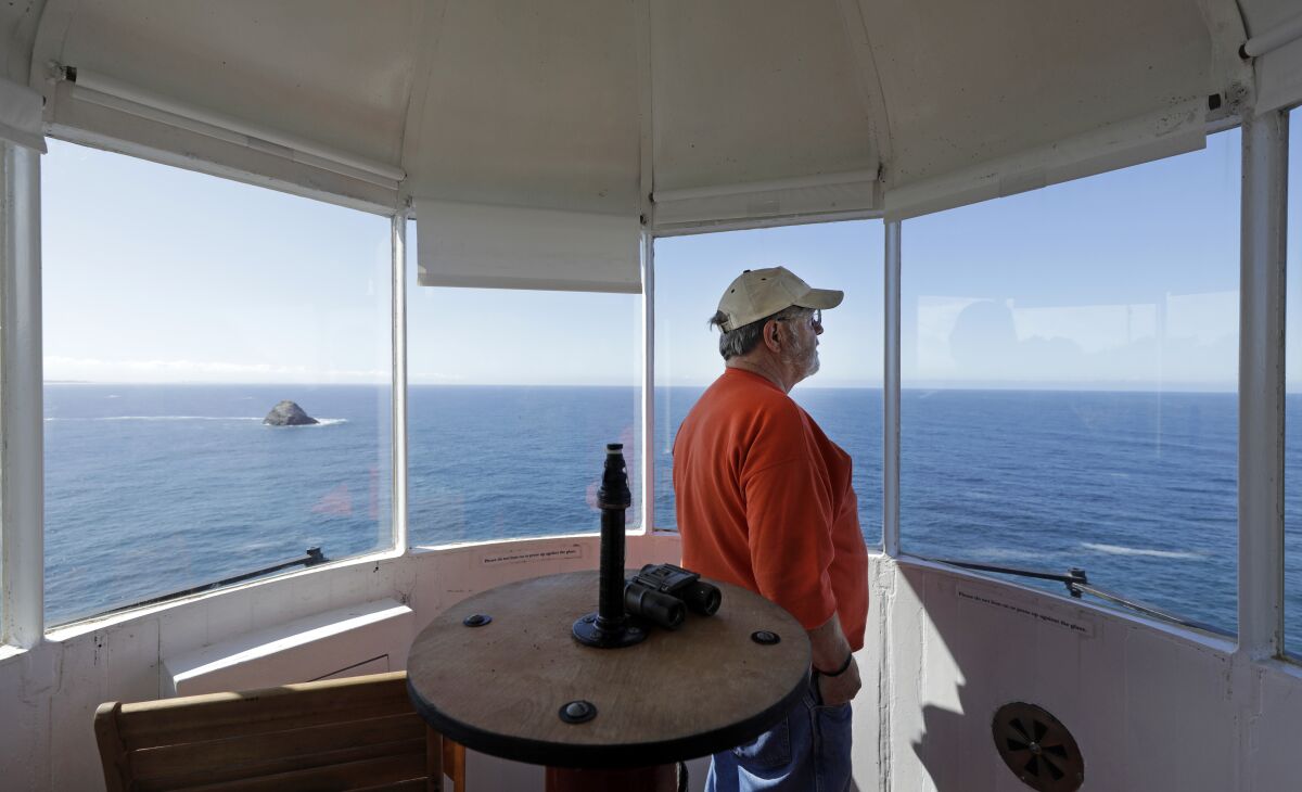 Scott Baker, a volunteer at the Trinidad Museum, takes in the scenery from the lantern room of the original 1871 Trinidad Head Lighthouse. A replica lighthouse was built in 1949 and housed the original fourth-order Fresnel lens and fog bell that were decommissioned by the Coast Guard.