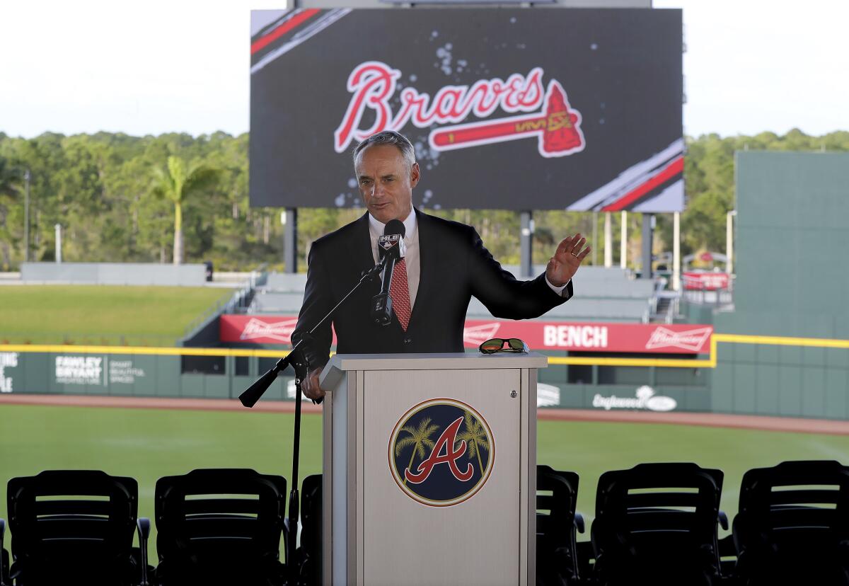 Major League Baseball Commissioner Rob Manfred speaks to reporters Sunday at the Atlanta Braves' spring training facility.