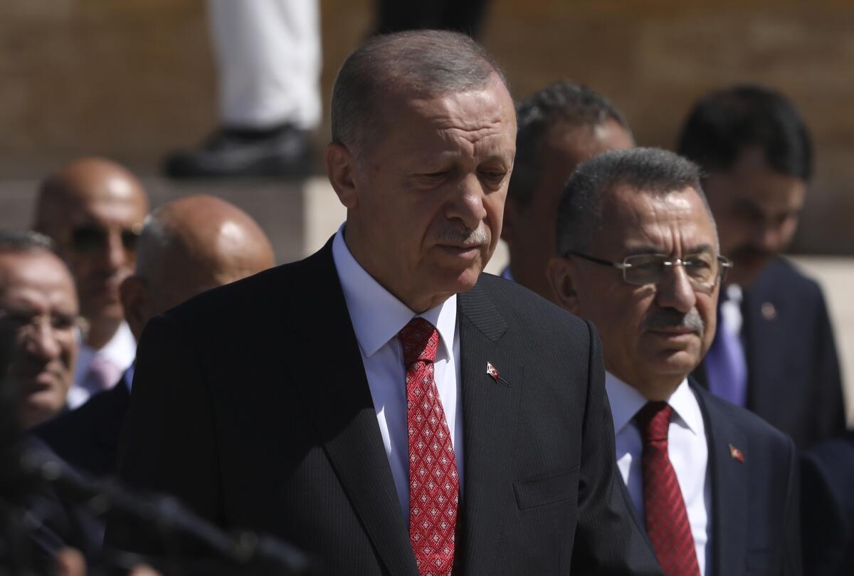 Turkey's President Recep Tayyip Erdogan and other officials walk to the mausoleum of modern Turkey's founder Mustafa Kemal Ataturk on Victory Day, in Ankara, Turkey, Tuesday, Aug. 30, 2022. Turkey is celebrating August 30 Victory Day, which marks the Turkish victory against Greek forces at the Battle of Dumlupinar, the crucial battle of the War of Independence in 1922 that led subsequently to the foundation of modern Turkish republic. (AP Photos/Burhan Ozbilici)