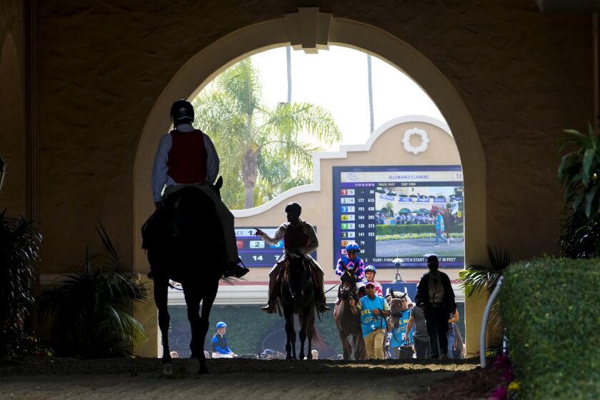Del Mar, CA - November 04: At the Del Mar Race Track on Thursday, Nov. 4, 2021 in Del Mar, CA., jockeys move from the paddock to the race track for the 1st race at Del Mar Race Track. (Nelvin C. Cepeda / The San Diego Union-Tribune)