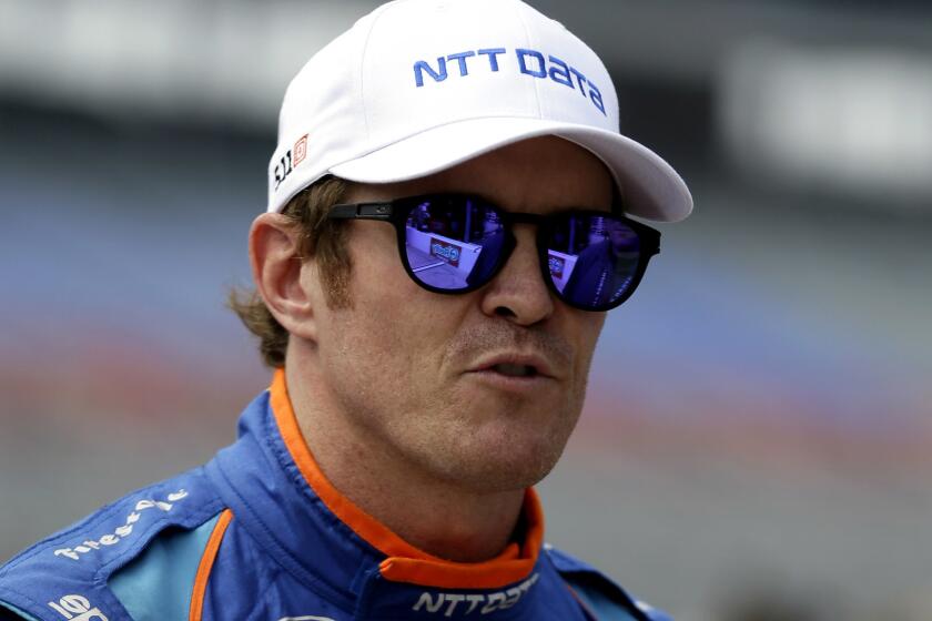 Scott Dixon of New Zealand talks with reporters on pit road after IndyCar auto racing qualifying for Saturday's IndyCar auto race at Texas Motor Speedway, Friday, June 9, 2017, in Fort Worth, Texas. (AP Photo/Tony Gutierrez)