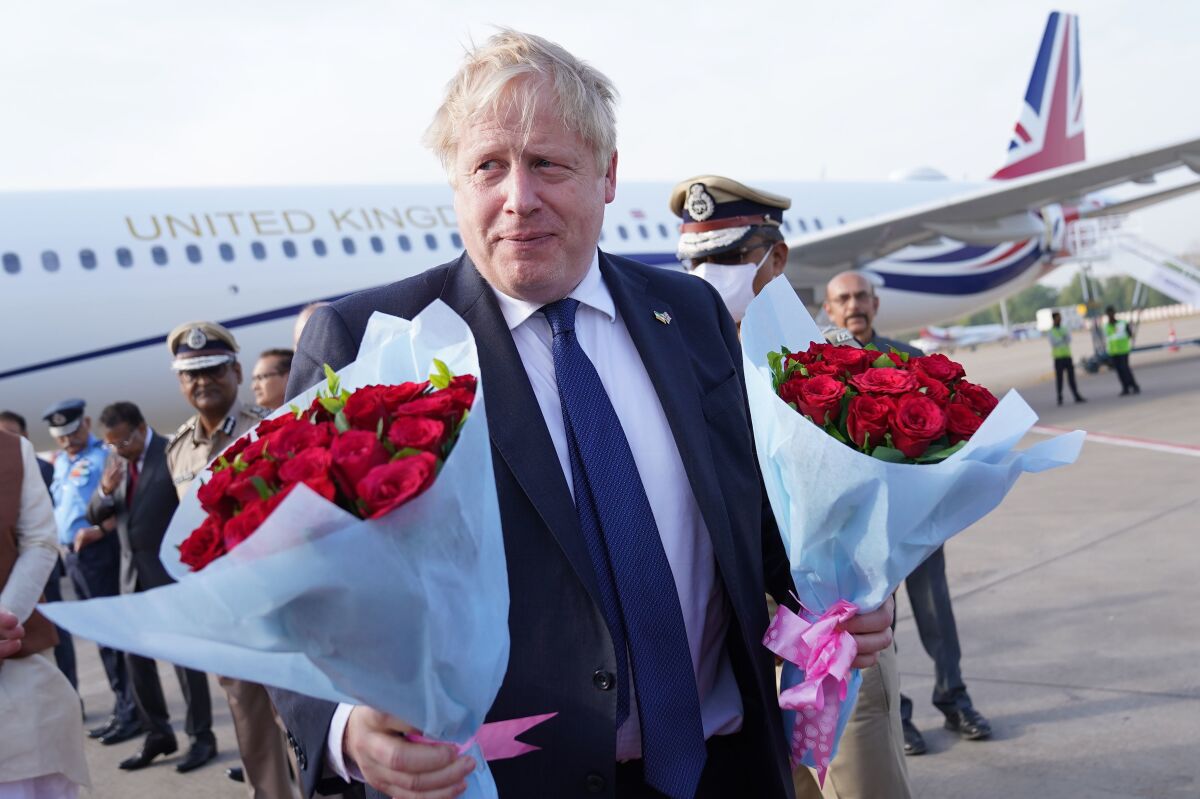 British Prime Minister Boris Johnson arrives at the Sarda Vallabhbhai Patel International airport in Ahmedabad, in the state of Gujarat, India, Thursday, April 21, 2022, as he begins a two day visit to the country. (Stefan Rousseau/Pool via AP)